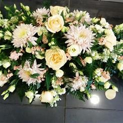 Peach and cream casket spray 