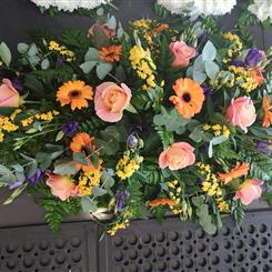 Coral rose casket spray