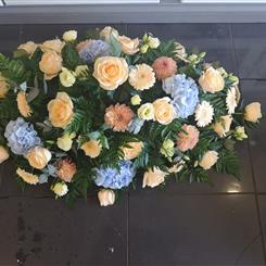 Peach and blue casket spray