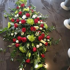 Red rose and green shamrock casket spray