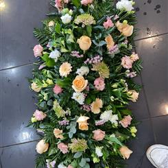  Peach and soft pink casket spray 