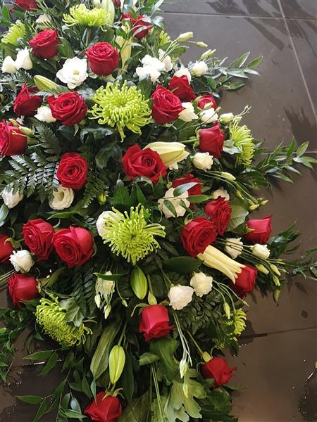 Red rose and green shamrock casket spray