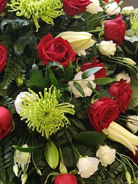 Red rose and green shamrock casket spray