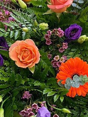 Vibrant coral Rose casket spray