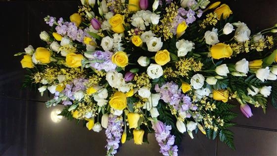 Yellow rose and lilac larkspur casket spray
