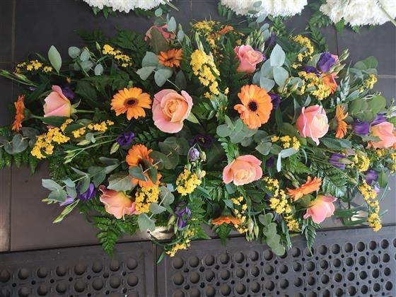 Coral rose casket spray
