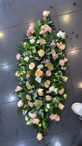 Peach and soft pink casket spray