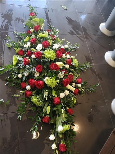 Red rose and green shamrock casket spray