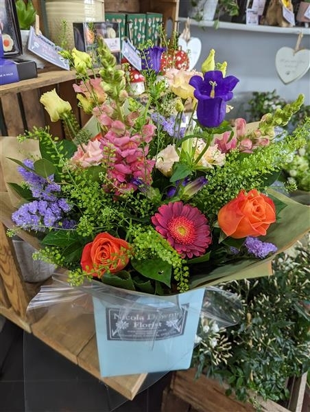 Vivienne A vibrant collection of orange and blue fresh blooms